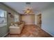 Living room with tile flooring, ceiling fan, comfortable seating, and natural light at 13057 89Th Ave, Seminole, FL 33776