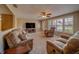 Cozy living room features ample seating, a ceiling fan, and natural light from the window at 13057 89Th Ave, Seminole, FL 33776