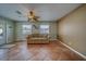 Cozy living room with tile flooring, ceiling fan, natural light, and comfortable seating at 13057 89Th Ave, Seminole, FL 33776