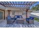 Inviting outdoor patio area with stylish wicker furniture and charming pergola, perfect for relaxation at 13057 89Th Ave, Seminole, FL 33776