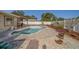 Inviting pool area with brick patio, landscaping, and a pergola, creating a perfect oasis for relaxation and enjoyment at 13057 89Th Ave, Seminole, FL 33776