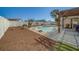 Outdoor area featuring a kidney shaped pool, brick patio, and pergola covered seating area, surrounded by greenery at 13057 89Th Ave, Seminole, FL 33776