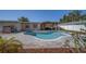 Refreshing kidney-shaped pool with brick patio and pergola-covered seating area, ideal for entertaining at 13057 89Th Ave, Seminole, FL 33776