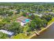 Aerial view of community amenities including a pool, tennis courts and lake at 134 Sycamore Ln # H, Oldsmar, FL 34677