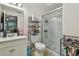 Modern bathroom with a glass-enclosed shower, vanity, and shelving unit at 134 Sycamore Ln # H, Oldsmar, FL 34677