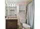 Cozy bathroom featuring a granite sink, vanity, and shower curtain at 134 Sycamore Ln # H, Oldsmar, FL 34677