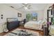Comfortable bedroom featuring wood floors, a ceiling fan, and two bright windows at 134 Sycamore Ln # H, Oldsmar, FL 34677