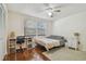 Bedroom with a ceiling fan, laminate flooring, a desk, and two windows at 134 Sycamore Ln # H, Oldsmar, FL 34677