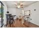 Dining area with a table, chairs, a breakfast bar, and hardwood floors at 134 Sycamore Ln # H, Oldsmar, FL 34677