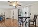 Open dining area with a sliding glass door leading to a balcony, and hardwood floors at 134 Sycamore Ln # H, Oldsmar, FL 34677