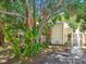 Home exterior with mature trees and front balcony at 134 Sycamore Ln # H, Oldsmar, FL 34677