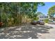 Condo exterior showcasing assigned parking and lush landscaping, complemented by mature trees at 134 Sycamore Ln # H, Oldsmar, FL 34677