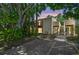 Charming condo exterior with lush greenery, a private balcony, and convenient parking spaces at 134 Sycamore Ln # H, Oldsmar, FL 34677