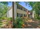 Two-story condo with green shutters and an inviting balcony, surrounded by lush landscaping at 134 Sycamore Ln # H, Oldsmar, FL 34677