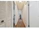 Long hallway with hardwood floors and white doors creates a clean and modern aesthetic at 134 Sycamore Ln # H, Oldsmar, FL 34677