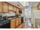 Functional kitchen featuring wood cabinets, black appliances, and hardwood floors at 134 Sycamore Ln # H, Oldsmar, FL 34677