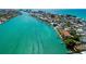Stunning aerial view of a waterfront community with turquoise water and lush landscaping at 135 92Nd Ave # 2, Treasure Island, FL 33706