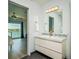 Bathroom featuring a modern vanity, attractive backsplash, and bedroom view for a spa-like retreat at 135 92Nd Ave # 2, Treasure Island, FL 33706