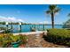 Stunning waterfront view with a private dock and lush tropical landscaping at 135 92Nd Ave # 2, Treasure Island, FL 33706
