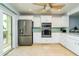 Chef's kitchen with stainless steel appliances, white cabinets, and granite countertops at 135 92Nd Ave # 2, Treasure Island, FL 33706