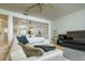 Spacious living room features a white sectional sofa, fan, and an open layout connecting to the kitchen at 135 92Nd Ave # 2, Treasure Island, FL 33706
