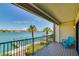 Balcony with railing offers water views, palm trees, and outdoor seating for relaxing and enjoying scenery at 135 92Nd Ave # 2, Treasure Island, FL 33706