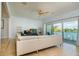 Living room showcases a white sectional and sliding glass doors with a scenic water view and exterior balcony at 135 92Nd Ave # 2, Treasure Island, FL 33706