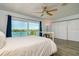 Main bedroom with a white bed offers sliding glass doors showcasing a water view and closet storage at 135 92Nd Ave # 2, Treasure Island, FL 33706