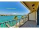 Balcony with water views, palm trees, and a metal railing offers a spot to relax and take in the scenery at 135 92Nd Ave # 2, Treasure Island, FL 33706