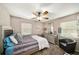 Bright bedroom featuring a decorative bedframe, large dresser, accent chair, and large window at 1399 Leeward Ave, Spring Hill, FL 34606