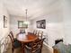 Traditional dining room with wood table and chairs, decorative lighting, and neutral wall color at 1399 Leeward Ave, Spring Hill, FL 34606