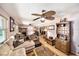Spacious living room with hardwood floors, ceiling fan, and plentiful vintage furniture at 1399 Leeward Ave, Spring Hill, FL 34606