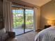 Bedroom showcasing view through sliding glass door to the backyard and side yard at 14678 Village Glen Cir, Tampa, FL 33618