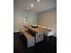 Dining room featuring a modern wooden table, bench seating, and neutral decor at 14678 Village Glen Cir, Tampa, FL 33618