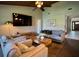 Spacious living room with vaulted wood ceiling, large sofa, and sliding glass doors at 14678 Village Glen Cir, Tampa, FL 33618