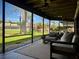 Relax on the screened porch with a view of the landscaped backyard and pond at 14678 Village Glen Cir, Tampa, FL 33618