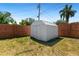 Backyard featuring a storage shed and a wood fence that wraps around the property at 1711 S Patlin Cir, Largo, FL 33770