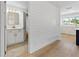 Bathroom featuring a modern vanity, marble floors, and bright lights, adjacent to white shiplap wall feature at 1711 S Patlin Cir, Largo, FL 33770