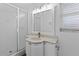 Updated bathroom features a glass shower enclosure and a vanity with modern lighting at 1711 S Patlin Cir, Largo, FL 33770
