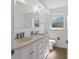 Bright bathroom featuring double sinks and a marble vanity at 1711 S Patlin Cir, Largo, FL 33770