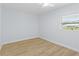 Clean bedroom with a new ceiling fan, window with blinds, neutral walls and wood-look flooring at 1711 S Patlin Cir, Largo, FL 33770
