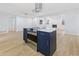 Modern kitchen island with stainless steel stove top at 1711 S Patlin Cir, Largo, FL 33770
