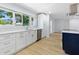Spacious kitchen featuring white cabinets, stainless steel appliances and hardwood floors at 1711 S Patlin Cir, Largo, FL 33770