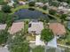Aerial view of the home's location near a pond, featuring a pool and well-maintained landscaping at 18714 Chemille Dr, Lutz, FL 33558