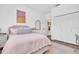 Bedroom with light pink bedding, wood floor, and closet, a calm and relaxing atmosphere at 18714 Chemille Dr, Lutz, FL 33558