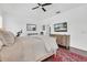 Bright bedroom featuring a neutral-toned bed, decorative rug, and large TV screen at 18714 Chemille Dr, Lutz, FL 33558