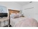 Bedroom featuring a wooden bed frame, closet, and a desk creating a relaxing retreat at 18714 Chemille Dr, Lutz, FL 33558