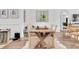Warm dining room with a rustic wooden table, comfortable seating, and natural lighting at 18714 Chemille Dr, Lutz, FL 33558