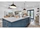 Kitchen island features white countertops, an undermount sink, and stylish barstools overlooking the Gathering room at 18714 Chemille Dr, Lutz, FL 33558