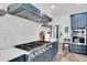 Chef's kitchen features a gas cooktop, stainless hood vent, and white subway tile backsplash at 18714 Chemille Dr, Lutz, FL 33558